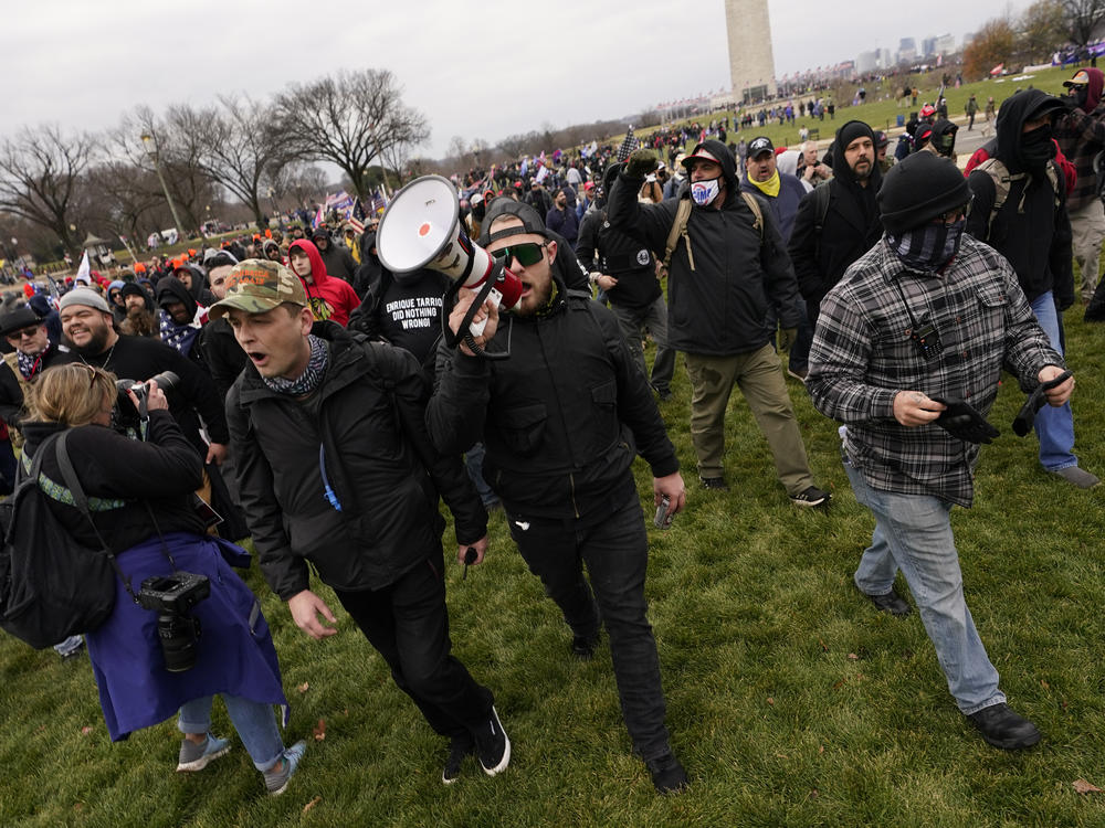Ethan Nordean, pictured on Jan. 6 with backward baseball hat and bullhorn, leads members of the far-right group Proud Boys in marching before the riot at the U.S. Capitol. Nordean, 30, of Auburn, Washington, has described himself as the sergeant-of-arms of the Seattle chapter of the Proud Boys.