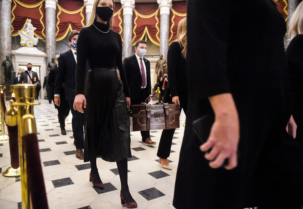 Senate pages carry the Electoral College ballot boxes at the Capitol on Jan. 7, 2021.