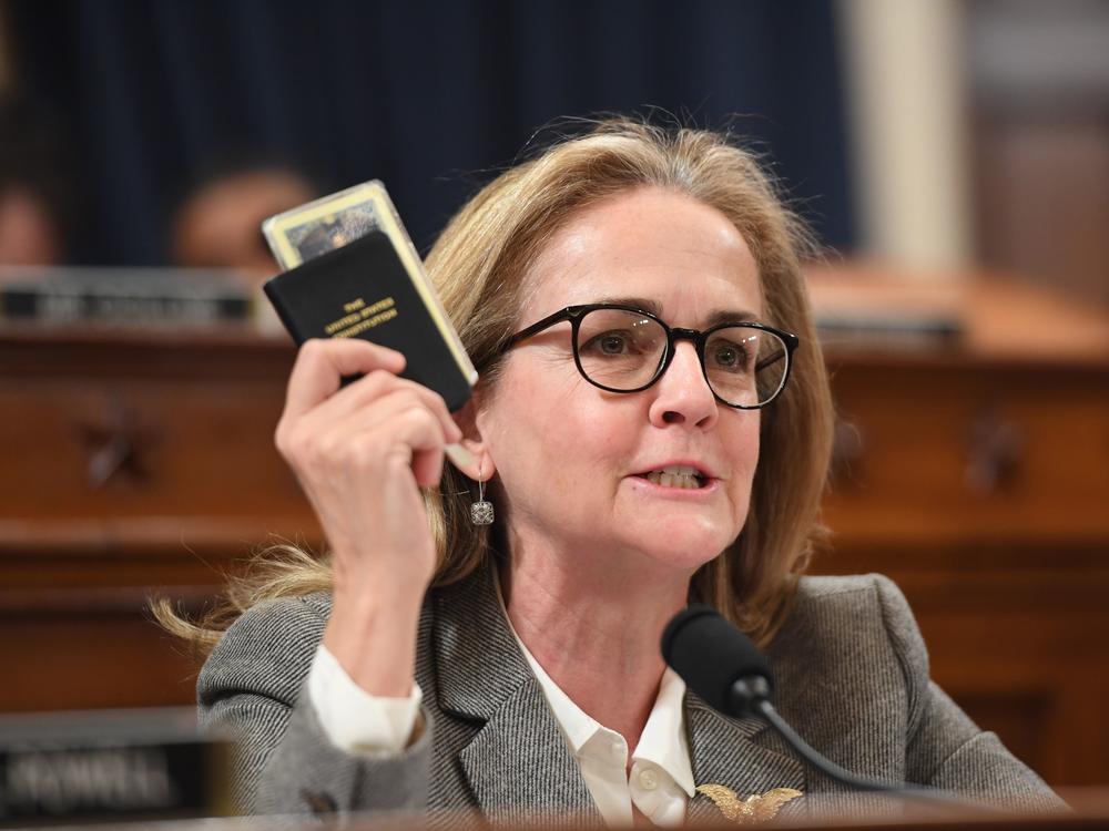 Rep. Madeleine Dean, D-Pa., holds a copy of the U.S. Constitution during a hearing related to former President Donald Trump's first impeachment in 2019.