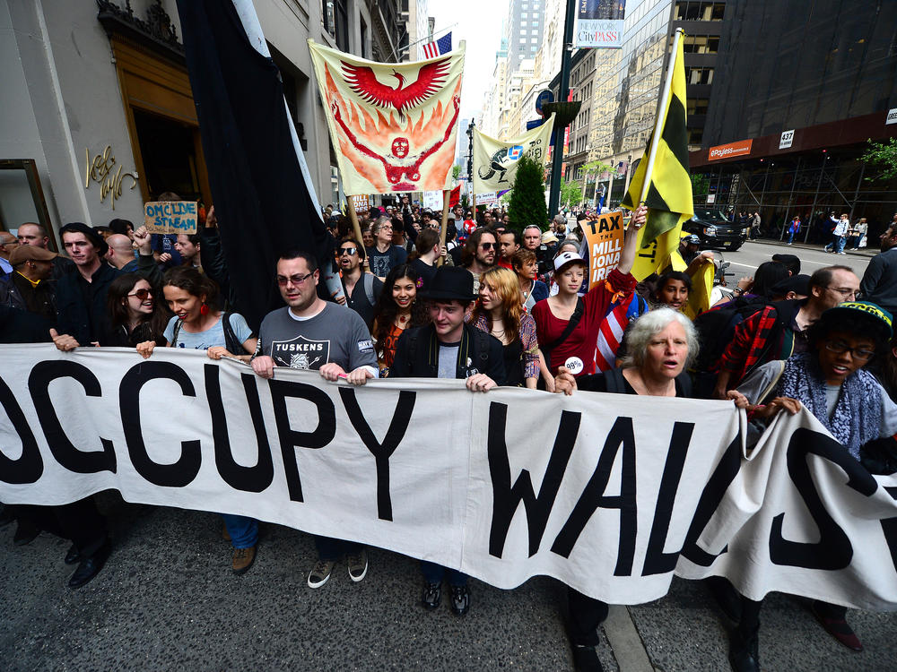 Occupy Wall Street participants march down Fifth Avenue in New York on May 1, 2012. Lingering anger over the 2008 global financial crisis has fueled several populist movements, including most recently, the battle waged by amateur investors coordinating in Reddit against hedge funds.
