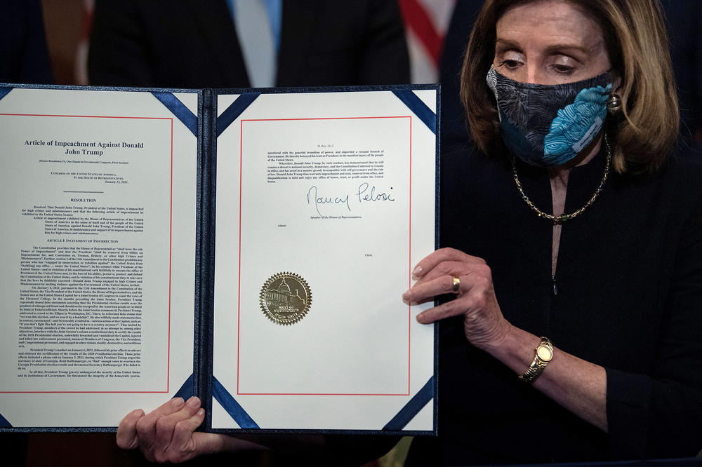 Speaker of the House Nancy Pelosi (D-CA), holds the signed article of impeachment, during an engrossment ceremony after the US House of Representatives voted to impeach the US President Donald Trump at the US Capitol, January 13, 2021, in Washington, DC.