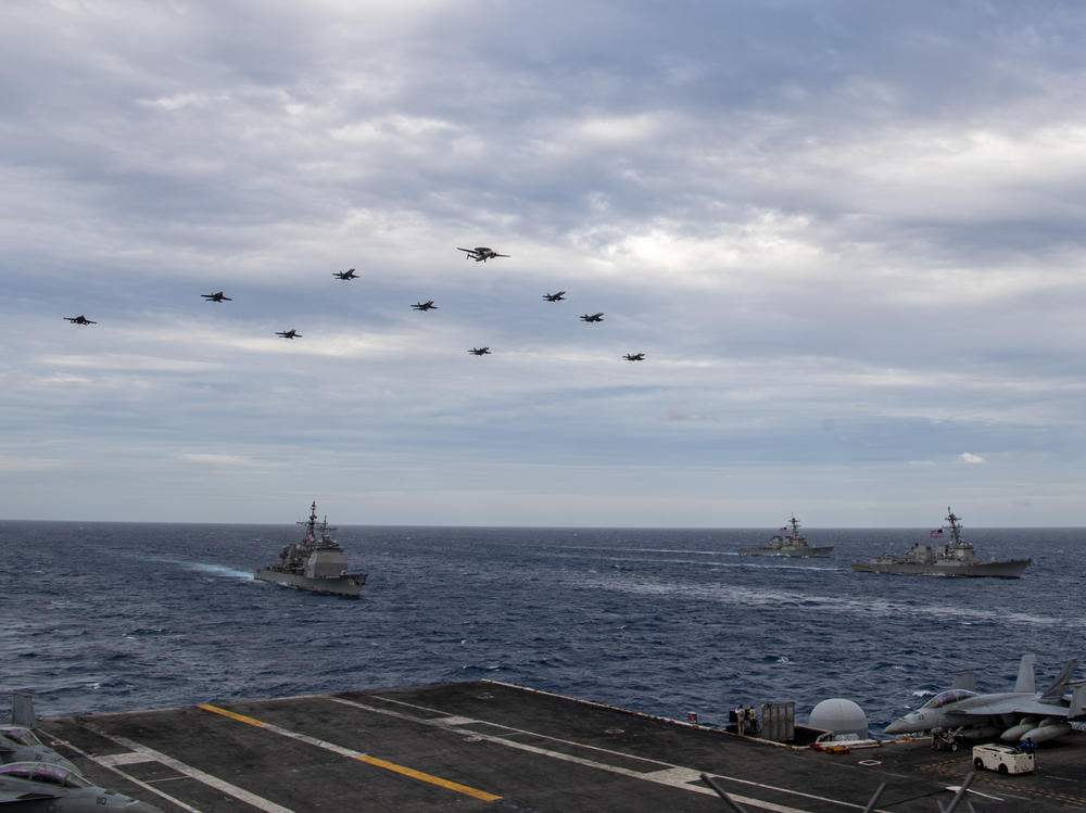 Aircraft assigned to Carrier Air Wing (CVW) 17 fly over the Theodore Roosevelt Carrier Strike Group and the Nimitz Carrier Strike Group in the South China Sea on Tuesday.