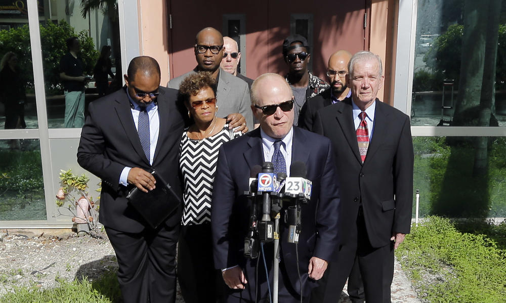Attorney David Schoen (center) talks to reporters during a news conference in 2015 with the family of Jermaine McBean, who was shot and killed by a sheriff's deputy while carrying an air rifle, in Fort Lauderdale, Fla.