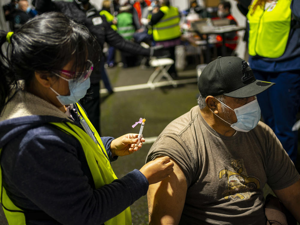 A person receives a COVID-19 shot in Federal Way, Wash., at a vaccination clinic for the Pacific Islander Community Association of Washington held on Feb. 4.