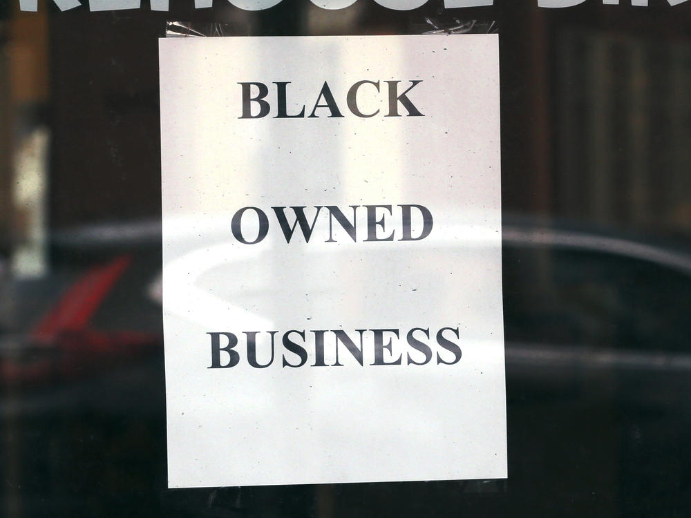 A store in Boston displays a sign noting its Black ownership on June 24, 2020. Black-owned businesses struggled to get coronavirus emergency loans last year, until community lenders stepped in to help.