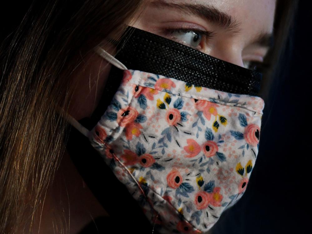 As new, more transmissible variants of the coronavirus spread, the CDC says wearing a cloth mask over a surgical mask offers increased protection against the virus.