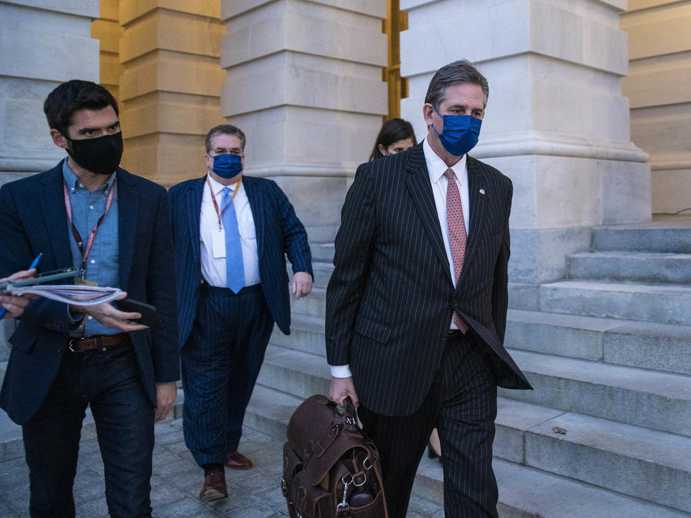 Bruce Castor, defense attorney for former President Donald Trump (center), departs the U.S. Capitol following the first day of the impeachment trial on Monday.