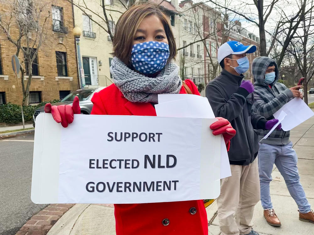 Demonstrator Khine Sann, 36, of Rockville, Md., holds a sign in support of the National League for Democracy, the ruling party lead by Nobel Peace Prize Laureate Aung San Suu Kyi, who was detained by the military on Feb. 1 and has not been heard from since.