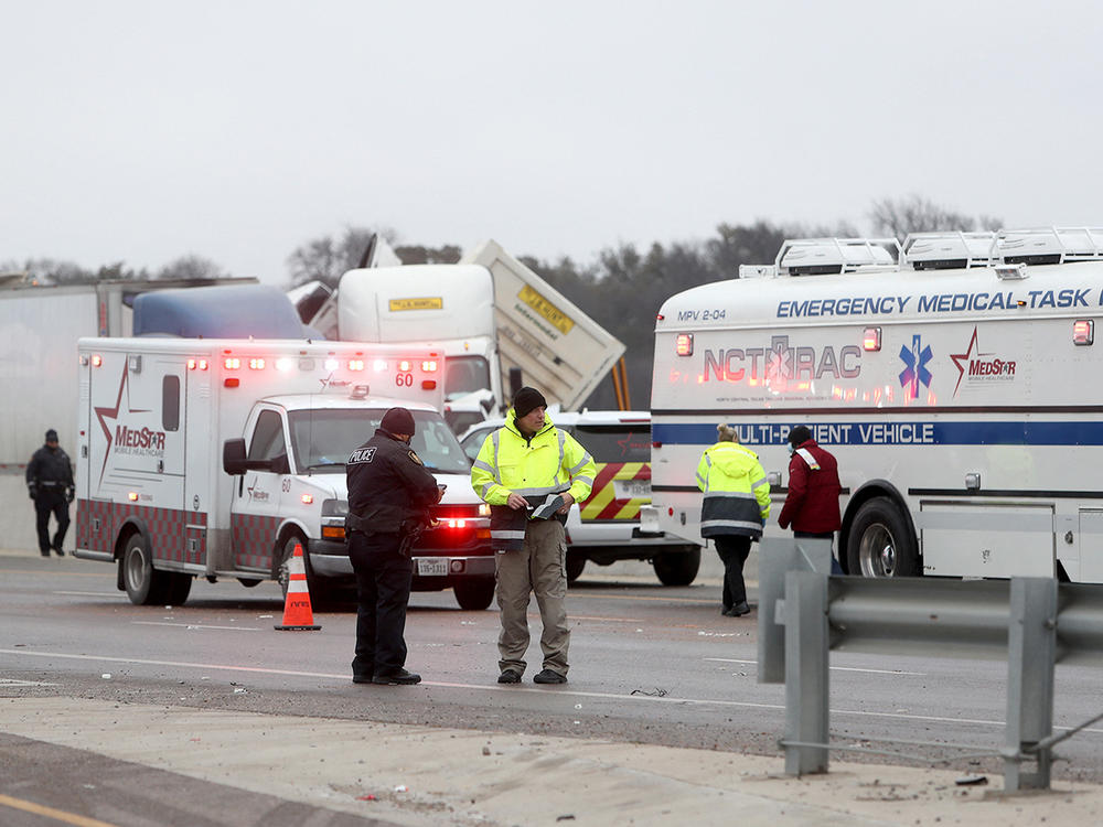 First responders arrive at the scene of a massive pileup of vehicles on Interstate 35W near downtown Fort Worth, Texas, on Thursday.