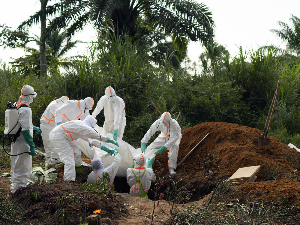 The Democratic Republic of Congo saw the end of its second-worst Ebola outbreak in June. More than 2,000 people died in that outbreak. Burial workers, seen above in 2019, follow safe burial practices to mitigate the spread of the virus.