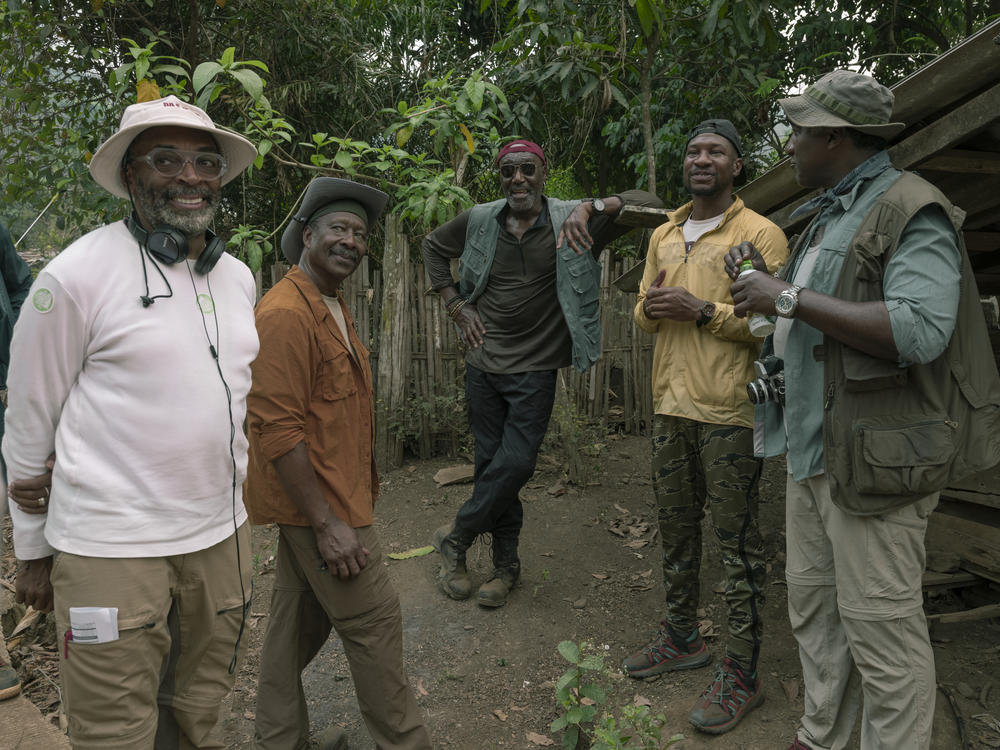 Spike Lee (left) consults with actors Clarke Peters, Delroy Lindo, Jonathan Majors and Norm Lewis on the set of <em>Da 5 Bloods.</em>