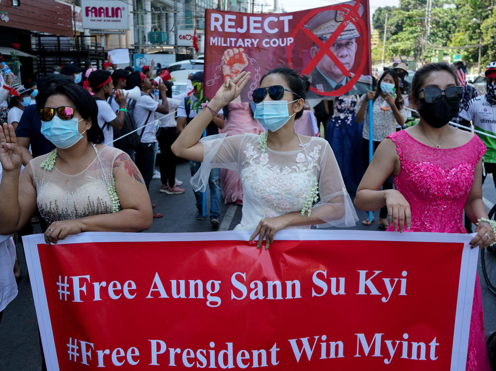 Women protest on Wednesday against the military coup that toppled the government led by Aung San Suu Kyi earlier this month. The Biden administration on Thursday announced sanctions against several of the coup leaders.