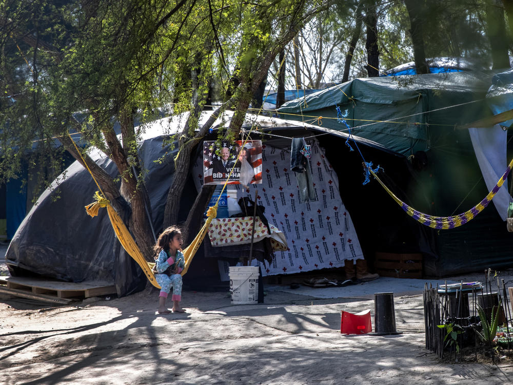 A Salvadoran girl sits inside a camp for asylum-seekers on Sunday in Matamoros, Mexico, where some 600 people who left Central America have been waiting for immigration court hearings.