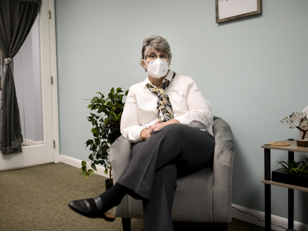 Jodee Pineau-Chaisson sits in her office in Springfield, Mass., on Jan. 12. Pineau-Chaisson, a social worker, contracted the coronavirus last May and continues to have symptoms even months after testing negative for the virus.