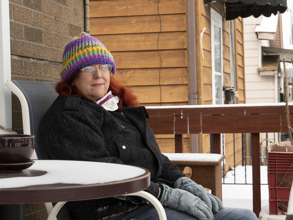 Sandra Griffin sits on her porch in St. Louis. The state of Missouri is demanding that more than 46,000 people pay back unemployment benefits they received. In December, the state told Griffin she owed nearly $8,000.