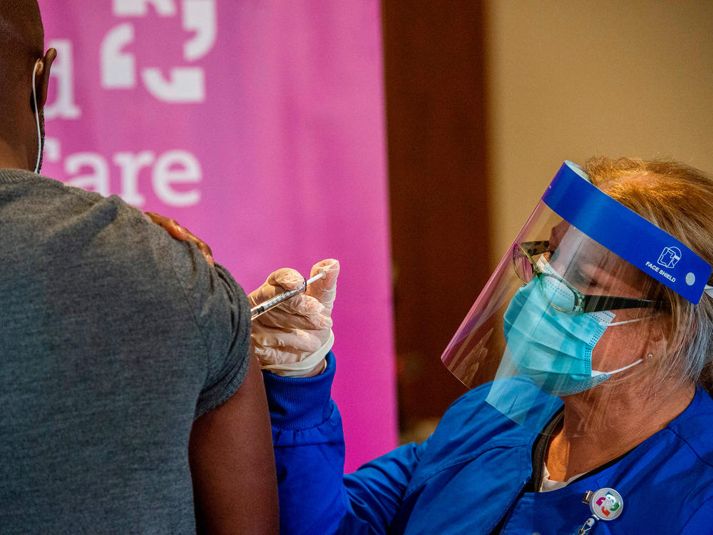 Nurse Keith Grant got his second dose of Pfizer's COVID-19 vaccine on schedule from registered nurse Valerie Massaro in January at the Hartford Convention Center — 21 days after his first immunization.