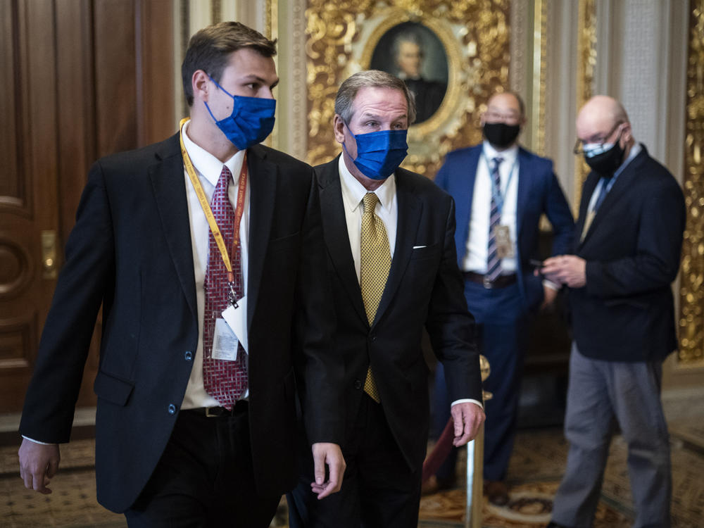 Michael van der Veen, lawyer for former President Donald Trump, walks to the Senate floor on the fourth day of the Senate impeachment trial, which had been expected to wrap up Saturday.