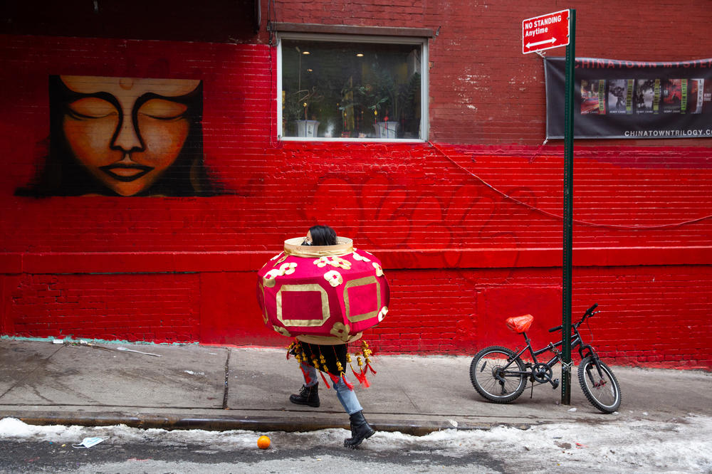 Rose Wong, Think!Chinatown's Lantern Artist in residence, dons a wearable lantern she designed for the celebration.