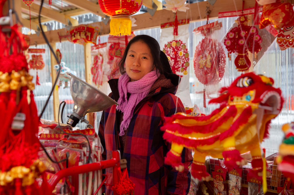 Alice Liu, the second-generation owner of Grand Tea and Imports, stands in front of her store in Chinatown.