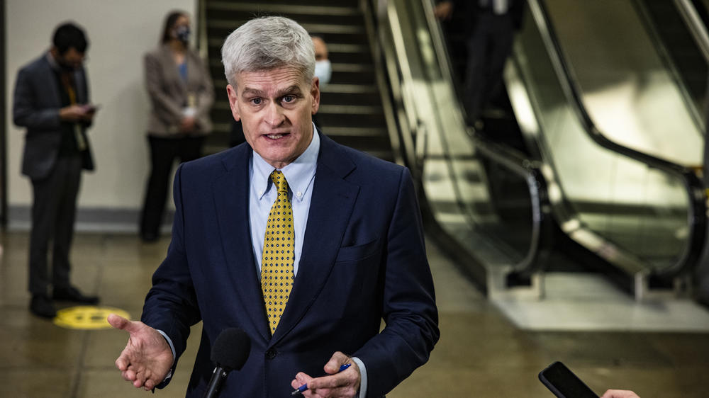 Sen. Bill Cassidy, seen talking to reporters on his way to the fourth day of the Senate impeachment trial, has been censured by the Louisiana GOP for his vote to convict Trump.