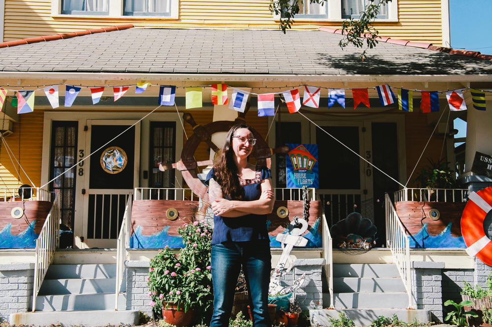 Megan Boudreaux, founder of Krewe of House Floats, stands outside her own home and the 'USS House Float,' in Algiers Point. 