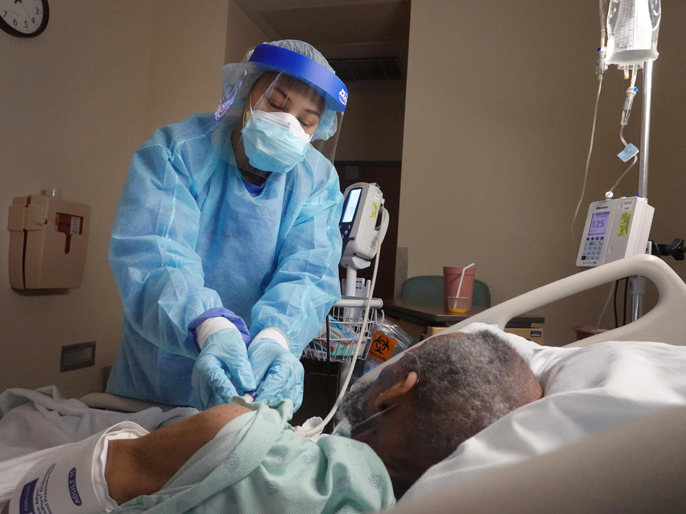 The average rate of confirmed coronavirus cases fell below 100,000 for the first time since Nov. 4, but health experts warn that highly infectious virus variants pose a serious risk to that downward trend.