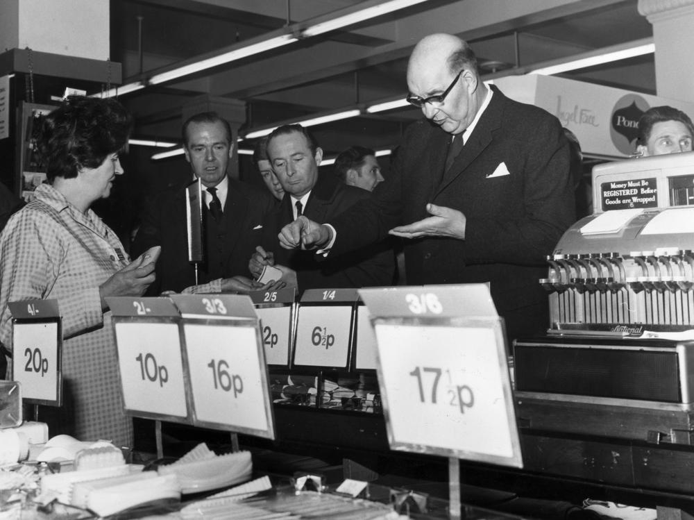 On the day of the official change to decimalized currency on Feb. 15, 1971, Lord Fiske, chairman of the Decimal Currency Board, makes a purchase at a Woolworths store in London.