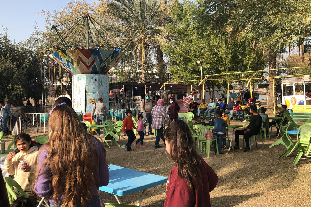 Tourists picnic at a park on the banks of the Euphrates river close to the site of the ancient city of Babylon.