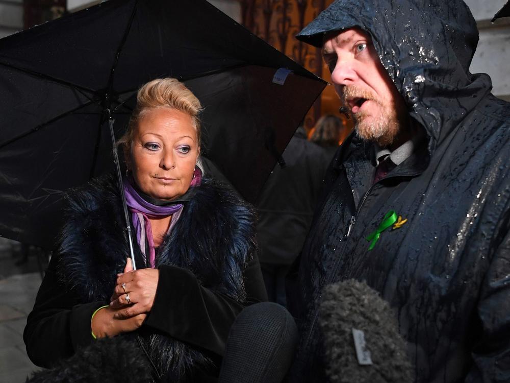 Charlotte Charles, the mother of teenage motorcyclist Harry Dunn, who was killed in a collision with an SUV driven by U.S. citizen Anne Sacoolas, stands beside her husband, Bruce Charles, as they discuss the case. Dunn's family is suing Sacoolas, who has claimed diplomatic immunity in the case.