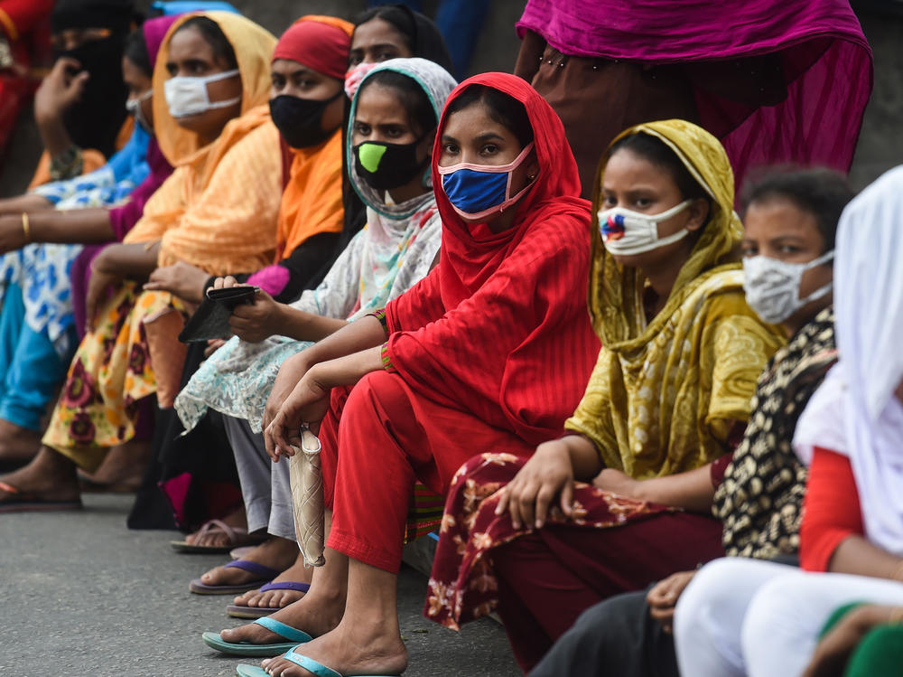 Workers from the garment sector block a road during a protest to demand payment of due wages, in Dhaka, Bangladesh, in April 2020. They claimed that factories had not paid them after retailers and brands cancelled orders due to worldwide lockdown measures.