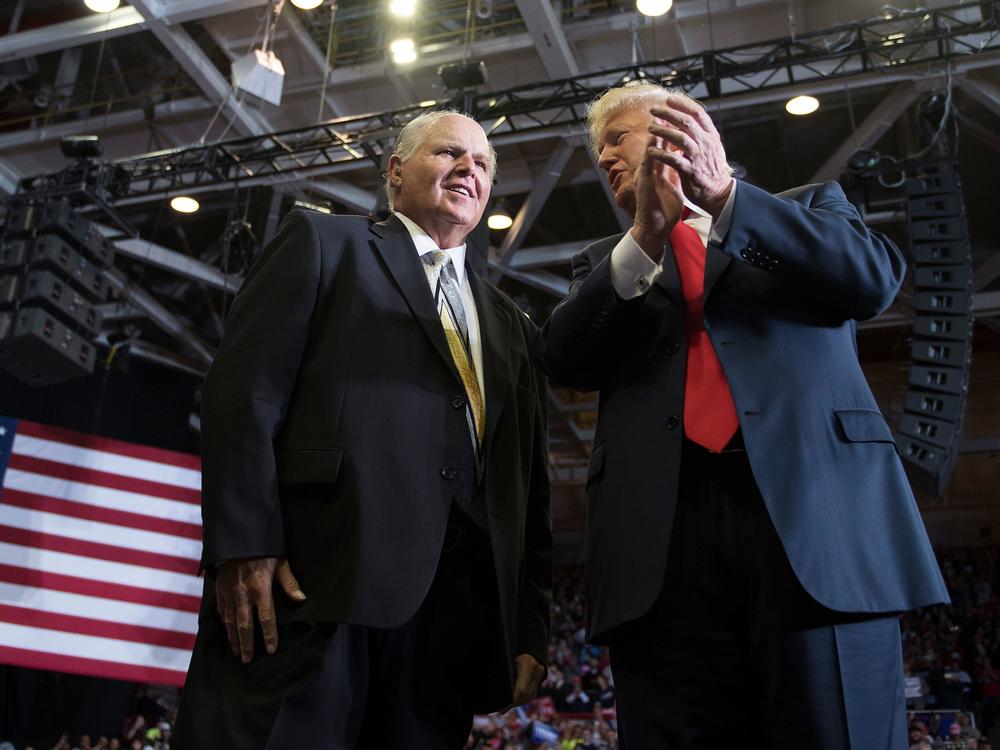 Talk show host Rush Limbaugh, pictured with then-President Donald Trump at a rally in November 2018, died on Wednesday.