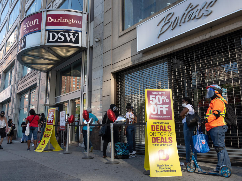 Shoppers line up near sale signs at a Burlington store in New York in June.