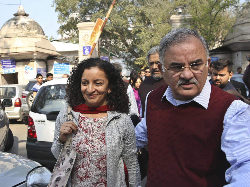 Indian journalist Priya Ramani (left) smiles as she leaves Patiala House Court in New Delhi in 2019. A New Delhi court on Wednesday acquitted Ramani of criminal defamation after she accused a former editor-turned-politician and junior external affairs minister, M.J. Akbar, of sexual harassment.