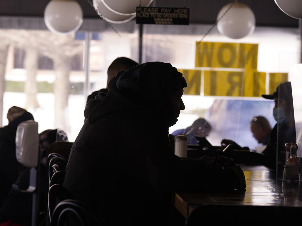 Patrons sit in a restaurant without power caused by cold weather blackouts on Tuesday in Richardson, Texas.