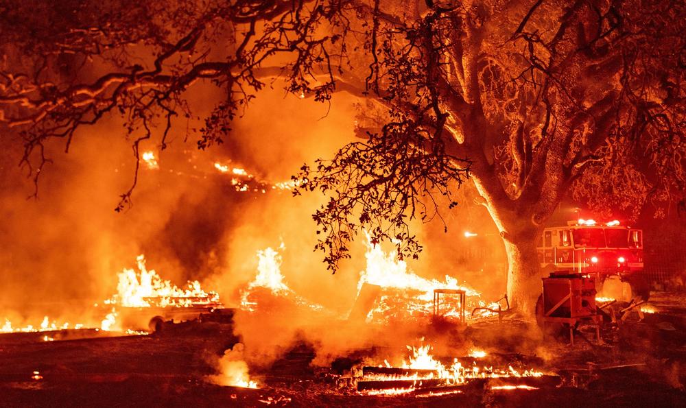 Firefighters work the scene as the Glass fire continues to burn in Calistoga, Calif., on Oct. 1, 2020. The United States's west coast experienced a record-breaking fire season in 2020, with five of the state's six biggest blazes in history burning simultaneously, and nearly four million acres scorched.