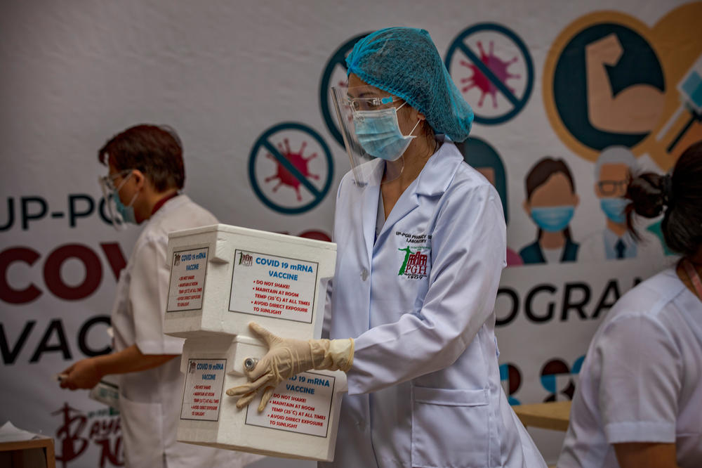 To get ready for the arrival of vaccines, the Philippine General Hospital held a mock vaccination drill on Feb 15. Above: A health worker carries boxes containing mock COVID-19 vaccines.