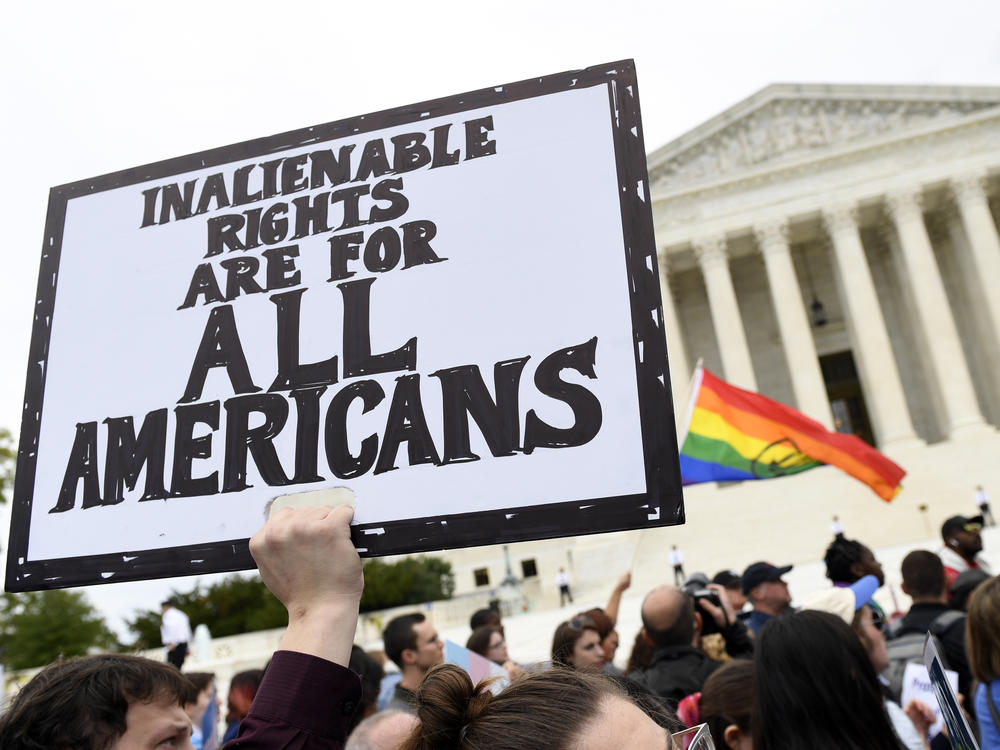 Protesters gather outside the Supreme Court in Washington where the Court on Oct. 8, 2019, as the court heard arguments in the first case of LGBT rights since the retirement of Supreme Court Justice Anthony Kennedy.