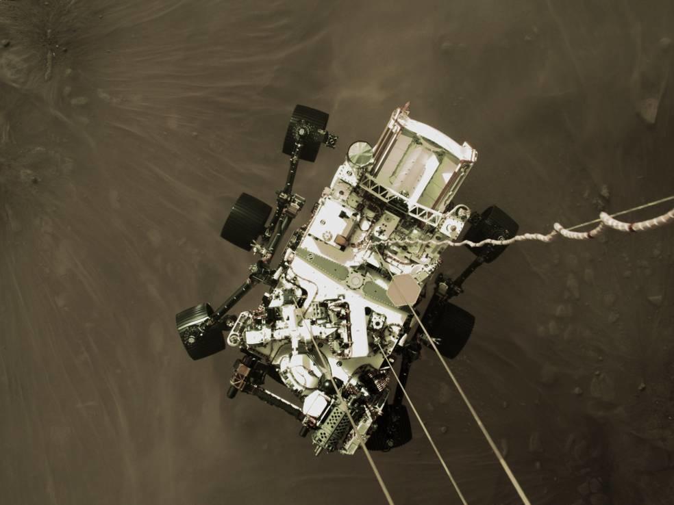 A camera on the descent stage of the Mars Perseverance spacecraft shows the rover being lowered to the planet's surface on Thursday.