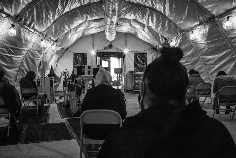At the peak of the winter surge, disaster tents are filled with COVID-19 patients. Inside the hospital, there are no open beds.