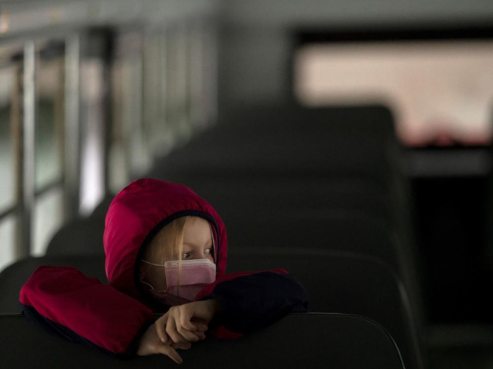 A first-grade student sits on the bus after a day of classes in Woodland, Wash., on Thursday.