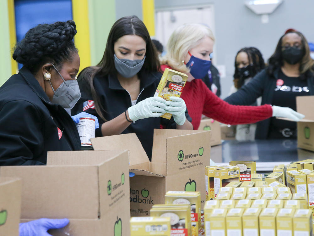 Reps. Sheila Jackson Lee (from left), Alexandria Ocasio-Cortez and Sylvia Garcia help distribute food at the Houston Food Bank on Saturday.