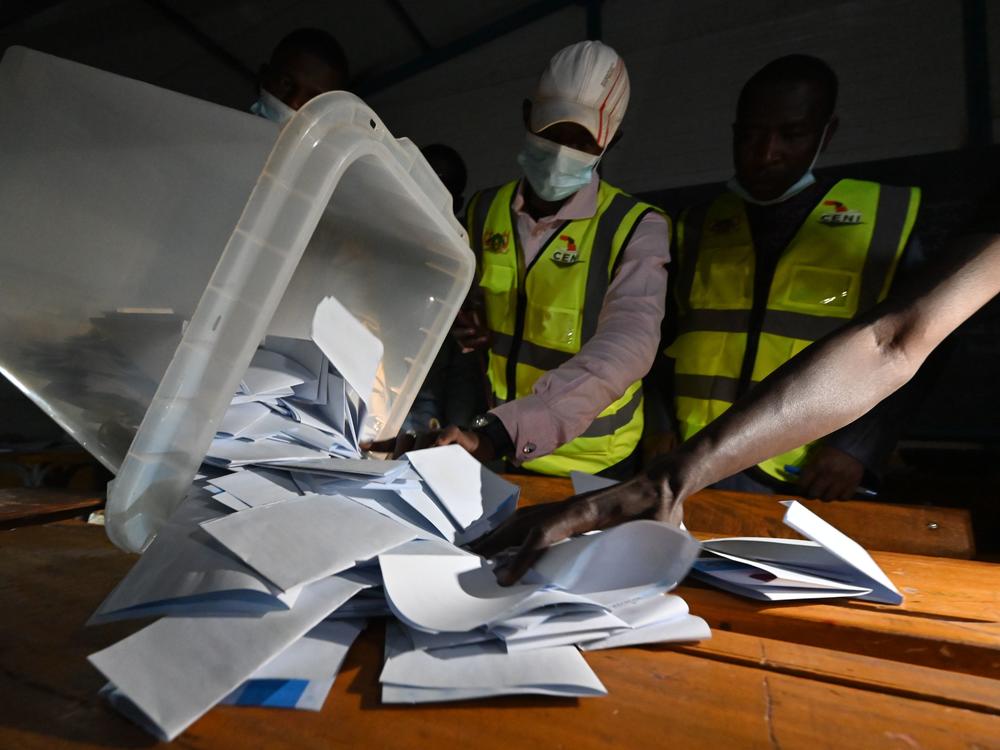 Niger's Electoral Commission workers count the ballots at a polling station during Niger's presidential election runoff in Niamey on Sunday. In the country's west, a vehicle carrying poll workers struck a landmine, killing seven and seriously wounding three others. It's unclear if the vehicle was deliberately attacked.