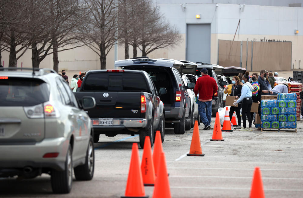 Thousands line up Sunday to receive food and water at a mass distribution site at NRG Stadium for Houston residents who are still without running water and electricity following last week's winter storm.