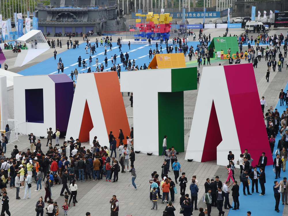 Visitors walk past the giant word 