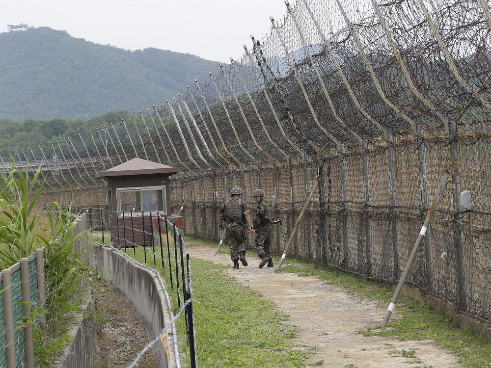 South Korean soldiers patrol while hikers visit the DMZ Peace Trail in the Demilitarized Zone in Goseong, South Korea. A defector from North Korea was apprehended in Goseong last week after evading South Korean guards for hours.