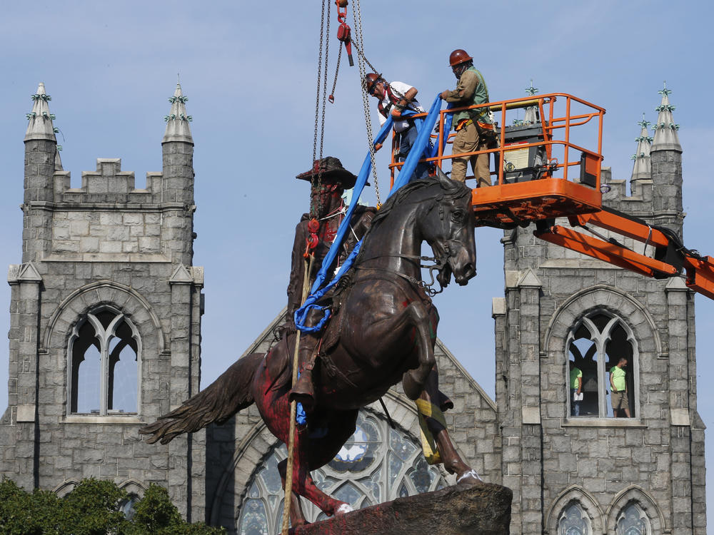 Crews attach straps in July to the statue of Confederate Gen. J.E.B. Stuart in Richmond, Va. The statue was one of several that were removed by the city in 2020 following nationwide protests against systemic racism.