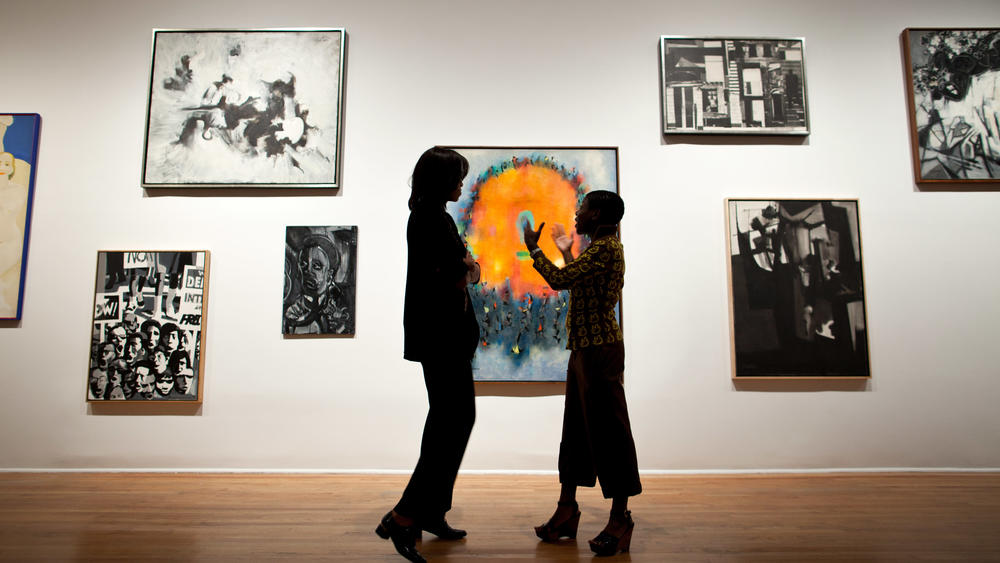 The documentary mentions the importance of the Studio Museum in Harlem in championing Black art. The museum is dedicated to promoting artists of African descent. Thelma Golden, the current director and chief curator, appears in the film and is a consulting producer. Pictured is Golden giving a tour of the New York City museum to Michelle Obama in 2011.