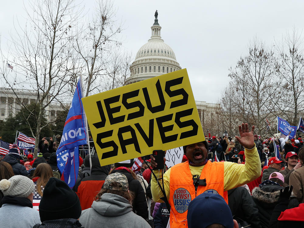 Protesters gather outside the U.S. Capitol on Jan. 6 in Washington, D.C., some with signs and symbols of Christianity. Pro-Trump protesters entered the U.S. Capitol that day after mass demonstrations in the nation's capital.