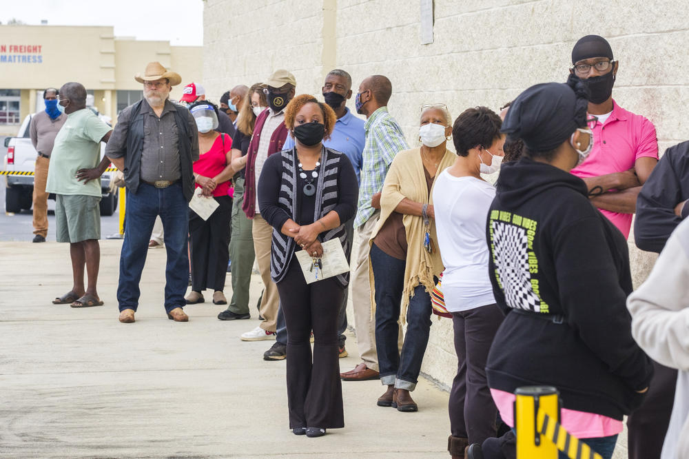 The line to vote outside the Macon-Bibb County Board of Elections in Georgia stretched around the building and lasted an hour and a half on the first day of early voting in October 2020.