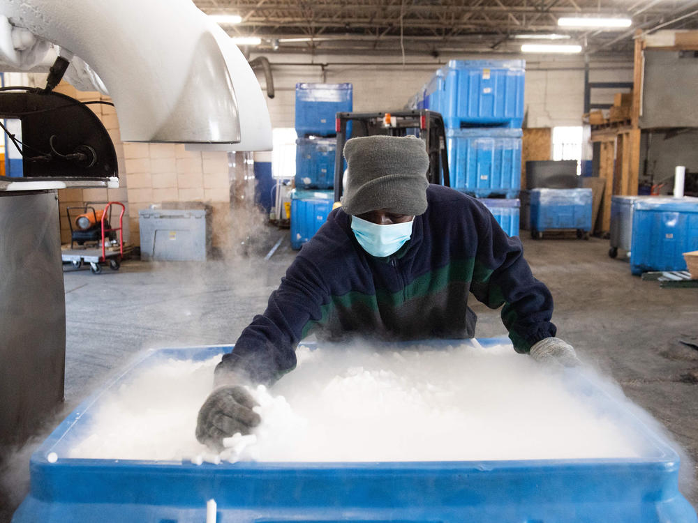 An employee makes dry ice pellets at Capitol Carbonic, a dry ice factory in Baltimore in Nov. 2020. Dry ice helps keep COVID-19 vaccines cool during transport.